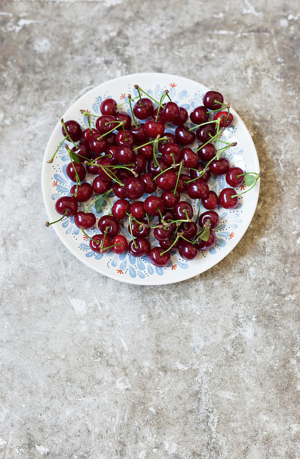 Dark Red Cherries On A Plate Photograph by Adel Bekefi