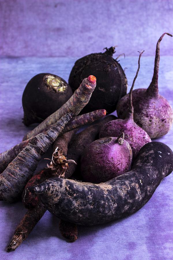 Dark Root Vegetables On A Grey Surface Photograph by Charlotte Von Elm