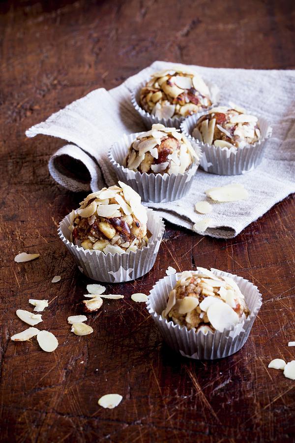Date Nut Balls With Almond Flakes Photograph by Claudia Timmann