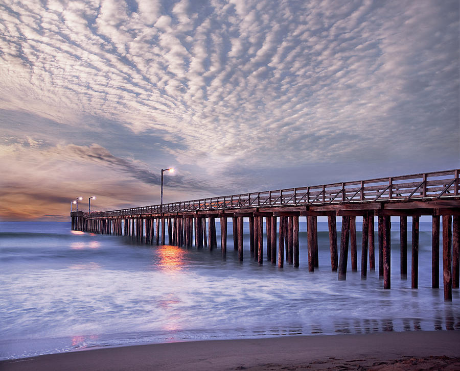 Dawn Clouds Over Pier In Pacific Ocean Photograph by Alice Cahill