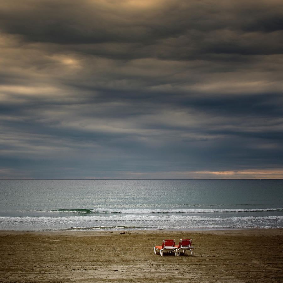Deckchairs In Lonely Beach On Storm Day Photograph by Iñaki De Luis