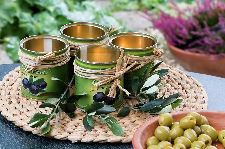 Decorated Olive Tins Wiht Twigs And A Bowl Of Olives Photograph by Inge Ofenstein