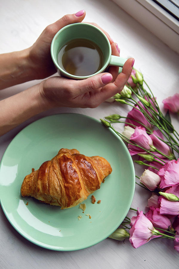 Decoration On The Window Of The Girls Hand Holding A Mug Of Tea And Croissants Photograph