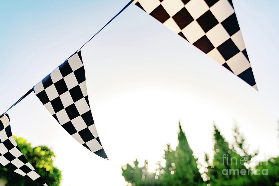 Decoration pennants with black and white squares like the flag of a car racing commissar. Photograph by Joaquin Corbalan