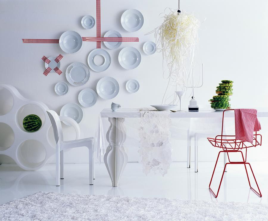 Decorative Wall Plates And Red Chair In White, Futuristic Dining Room Photograph by Matteo Manduzio