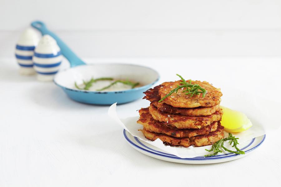Deep Fried Fish Fritters With A Lemon Wedge And Samphire Photograph by Charlotte Tolhurst