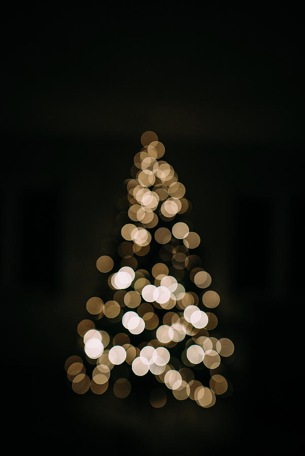 Defocused Image Of Illuminated Christmas Tree In Darkroom At Home ...