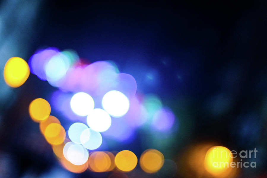 Defocused urban night background with colorful circles. Photograph by Joaquin Corbalan