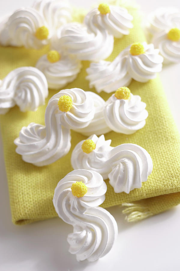 Delicate Meringue Shapes With Yellow Sugar Decorations Photograph by Teubner Foodfoto