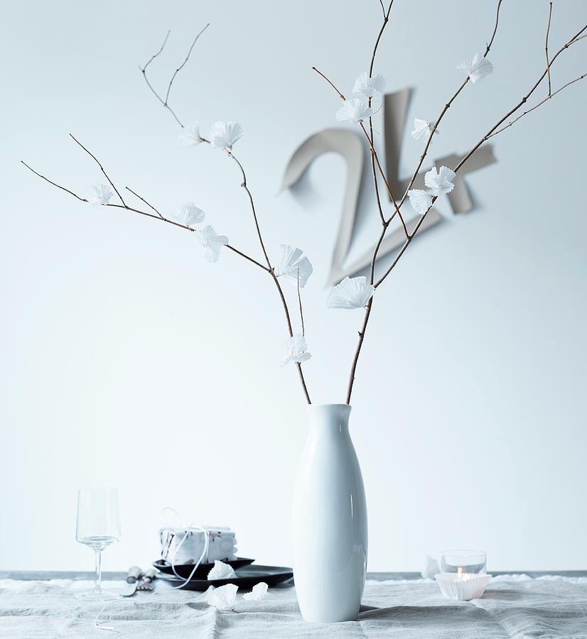 Delicate, White Paper Flowers On Dry Branches In Porcelain Vase Photograph by Andreas Hoernisch