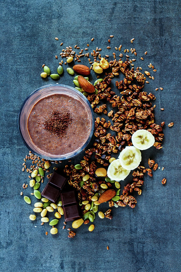 Delicious Banana Chocolate Smoothie With Homemade Granola, Nuts And Seeds On Dark Vintage Backdrop Photograph by Yuliya Gontar