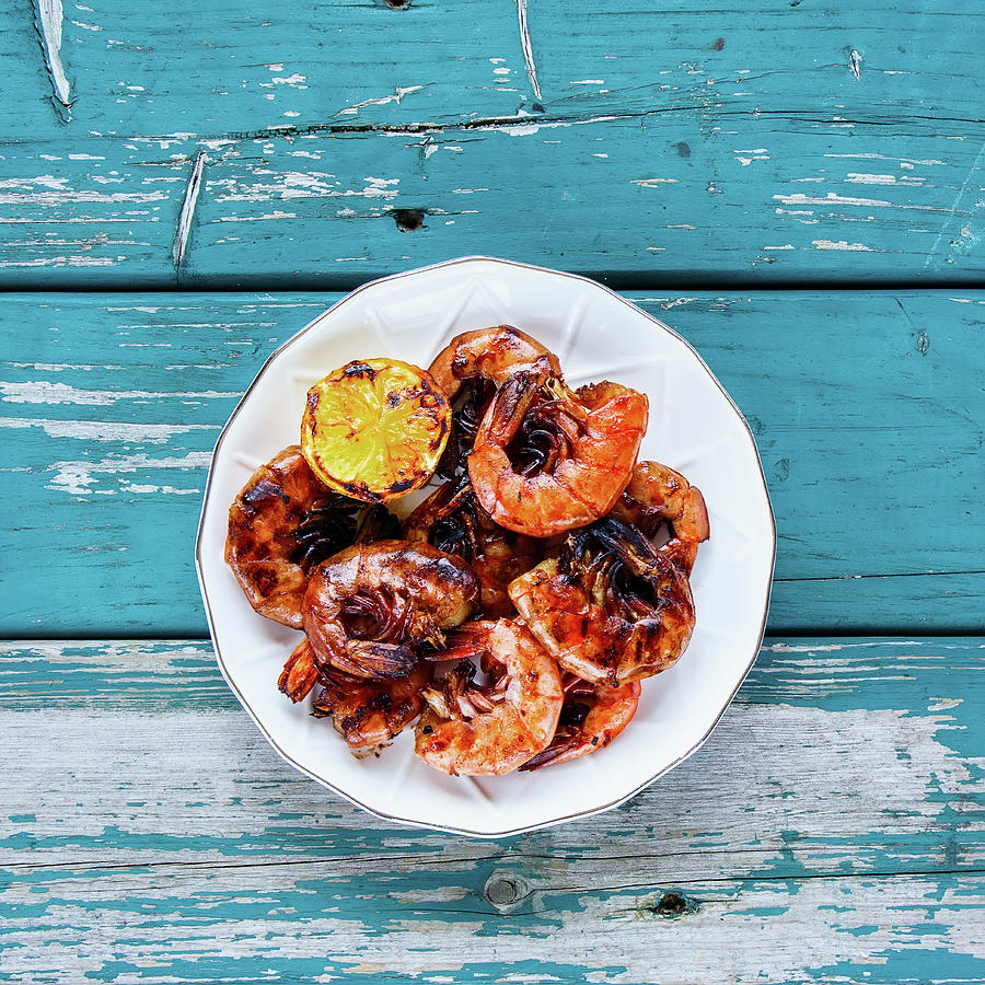 Delicious Grilled Prawns Shrimps On Plate With Lemon On Turquoise Vintage Table From Above Photograph by Yuliya Gontar