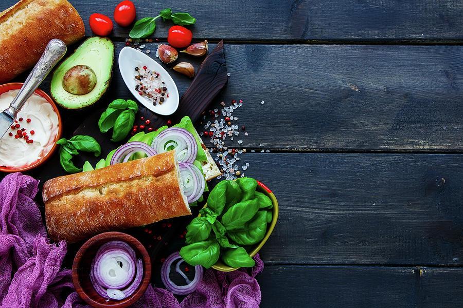 Delicious Vegetarian Sandwich with Avocado, Tomato, Onion, Cream Cheese, Herbs And Spices On Dark Rustic Background Photograph by Yuliya Gontar