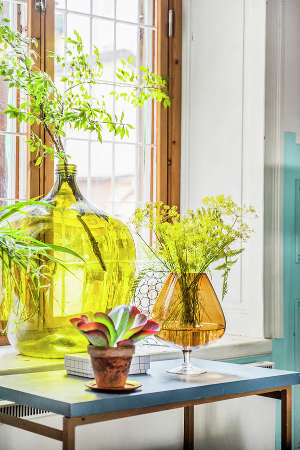 Demijohn And Large Amber Glass Used As Vases In Front Of Window Photograph by Magdalena Bjrnsdotter
