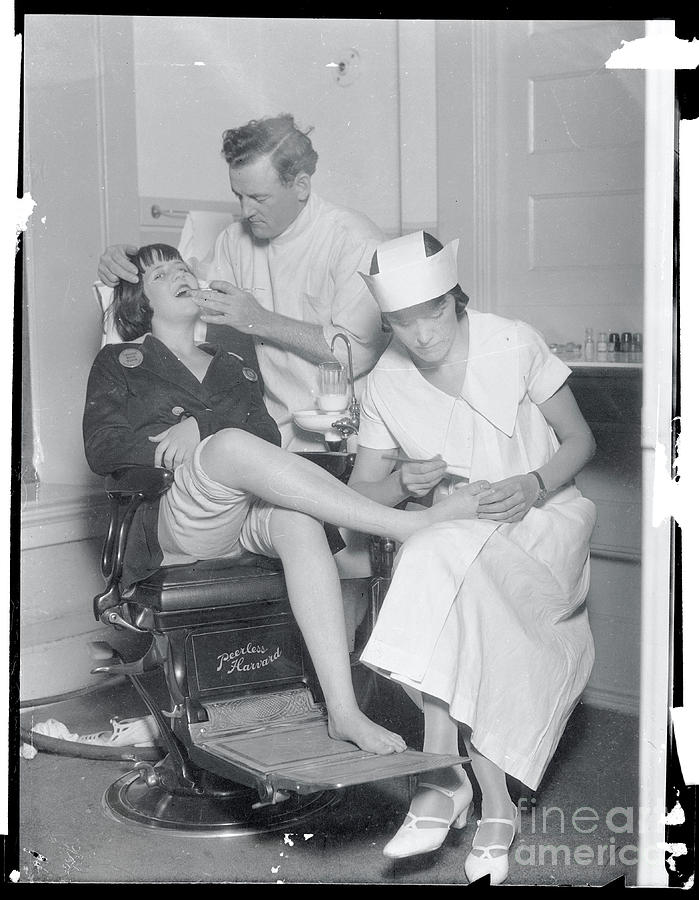 Dentist And Nurse Working On Teeth Photograph by Bettmann