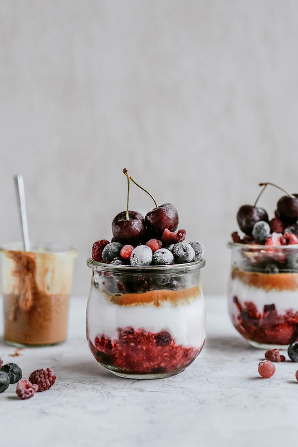 Dessert In A Jar With Raspberries Blueberries Cherries And Peanut Butter Photograph by Kasia Wala