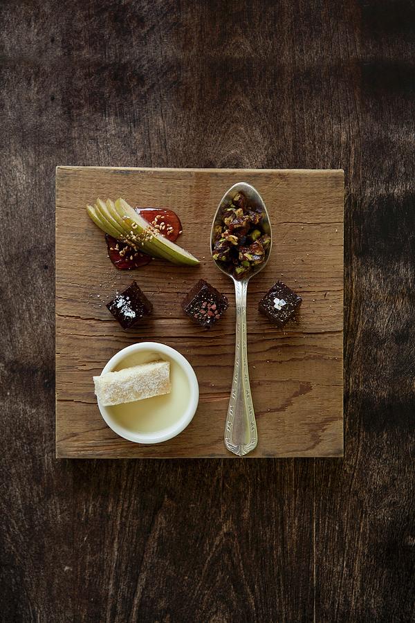 Dessert Sampler; Chocolate Boka Negra, Pistachio Brittle, Blood Orange Panna Cotta And Shortbread; All On A Cutting Board Photograph by Fleischman, Richard