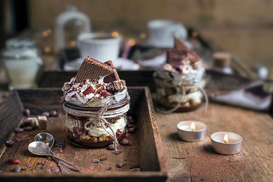 Dessert With Mascarpone, Chocolote And Hazelnuts, Topped With Cocoa Powder And Whipped Cream Served On A Wooden Table Photograph by Natalia Mantur