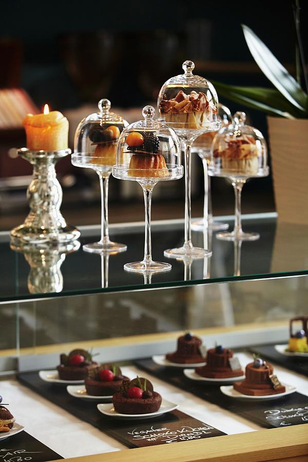 Desserts Under Mini Glass Cloches On A Bar In A Restaurant Photograph by Herbert Lehmann