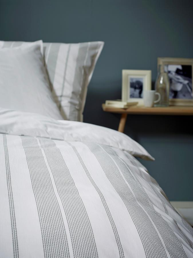 Detail Of Striped Bed Linen And Bedside Table In Background Photograph by Michael Lffler