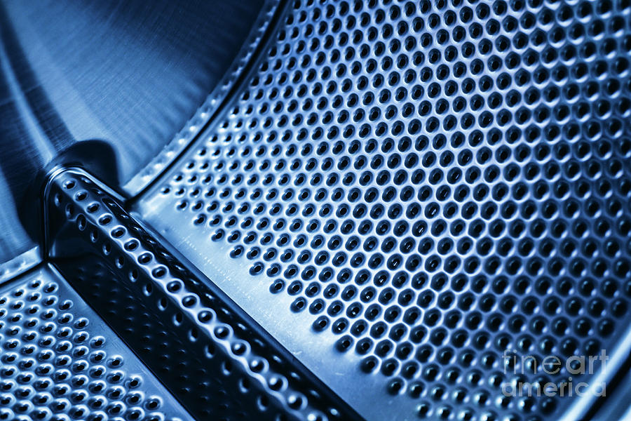 Detail of the drum of a washing machine, steel industrial texture with holes. Photograph by Joaquin Corbalan