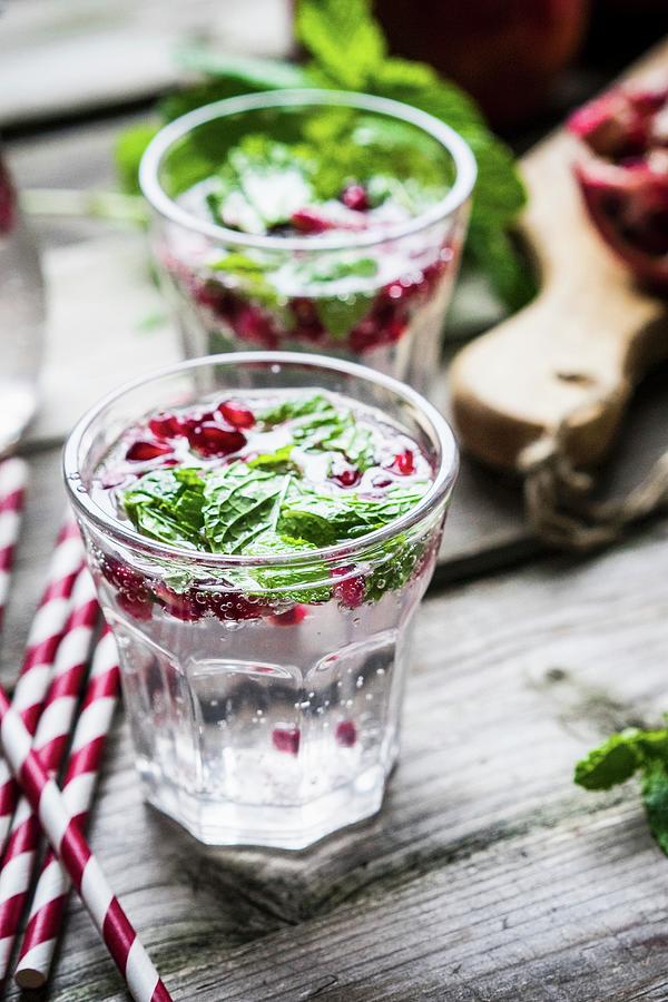 Detox Drinks With Lemon Water, Mint And Pomegranate Seeds Photograph by Alena Haurylik