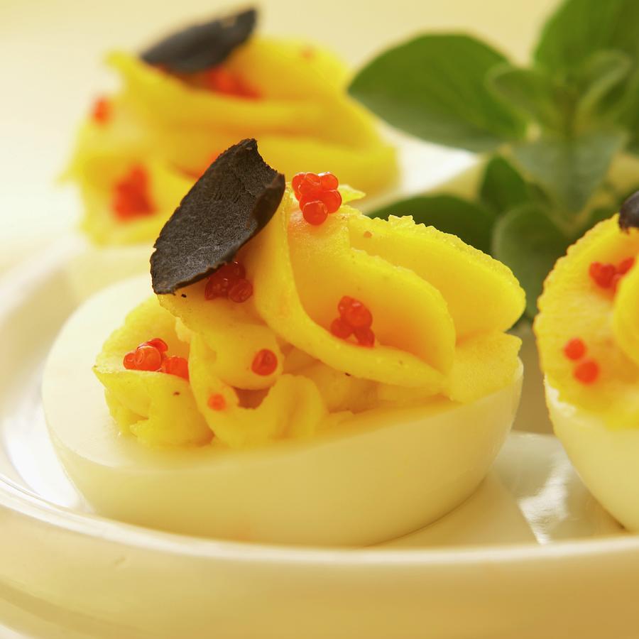 Deviled Eggs With Red Caviar And Truffle Mushroom Slices Photograph by Paul Poplis