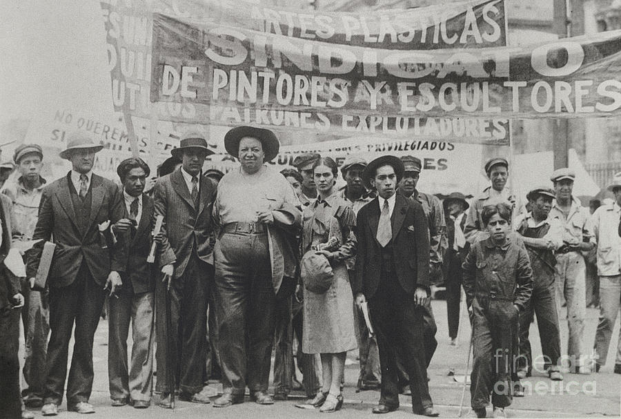 Tina Modotti Photograph - Diego Rivera And Frida Kahlo In The May Day Parade, Mexico City, 1st May 1929 by Tina Modotti