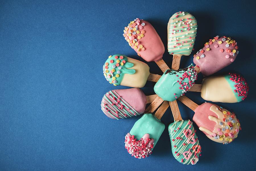 Different Cake Pops In The Shape Of Ice Lollies With Brightly Coloured Icing Photograph by Ltummy