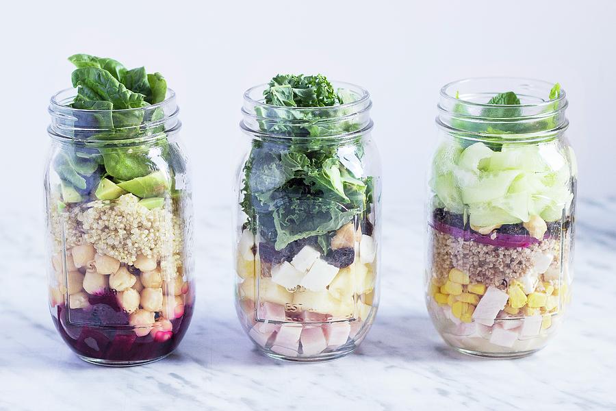 Different Layered Salads In Glass Jars Photograph by Vernica Orti