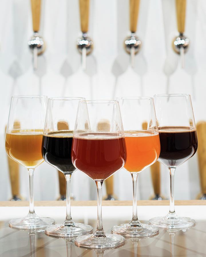 Different Types Of Beer Displayed In Wine Glasses Photograph by Reiand