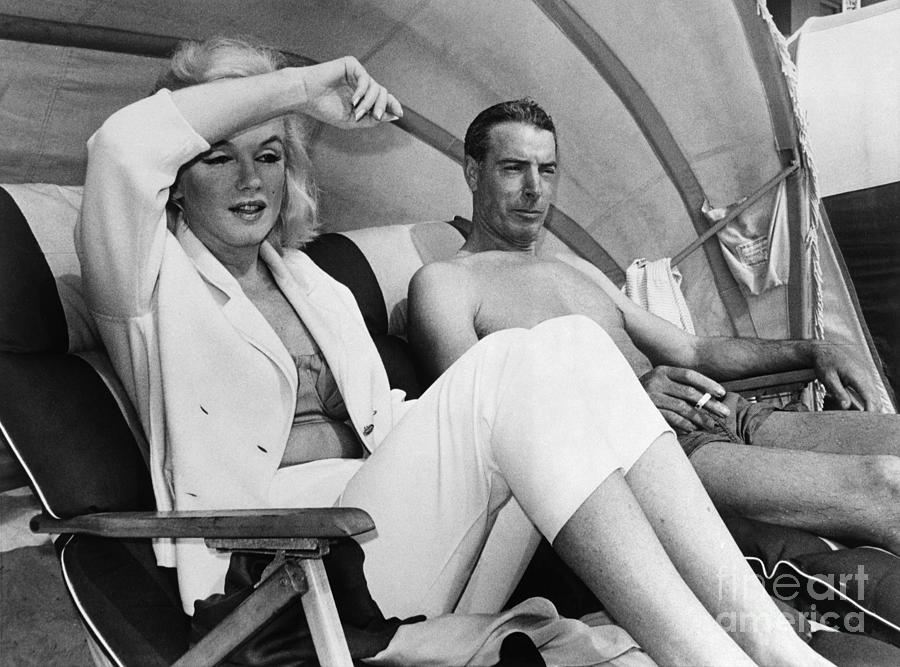 Dimaggio And Monroe Lounging On Beach Photograph by Bettmann