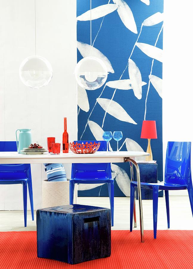 Dining Table, Stool, Plastic Chairs & Photographic Wallpaper In Interior In Shades Of Blue & Red Photograph by Matteo Manduzio