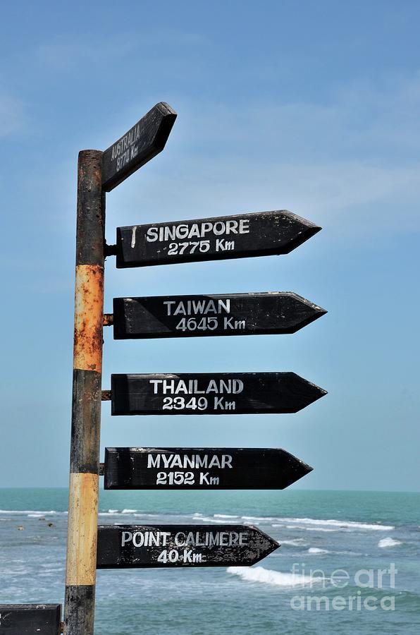 Directional distance arrows with kilometers to Australia and Singapore at beach in Jaffna Sri Lanka Photograph by Imran Ahmed
