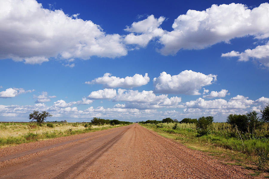 Dirt Road And Puffy Clouds Photograph by Jeremy Woodhouse