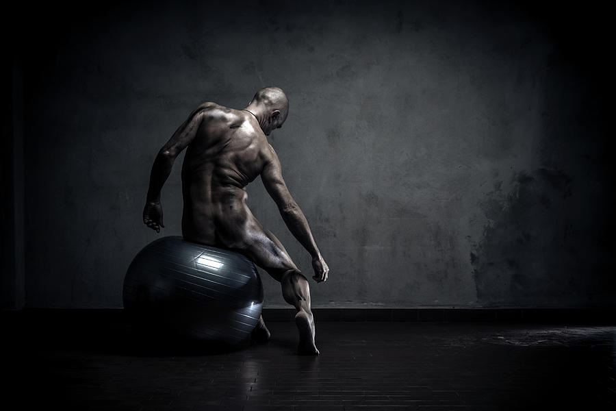 Dirty Naked Man Sitting On Gym Ball Photograph by Paolomartinezphotography