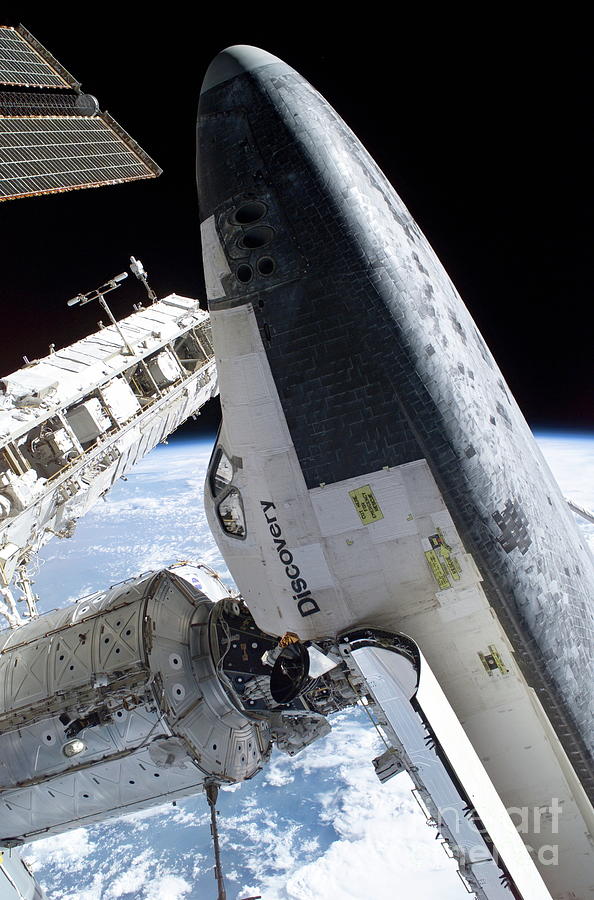 Space Photograph - Discovery Docked To The Iss by Nasa/science Photo Library