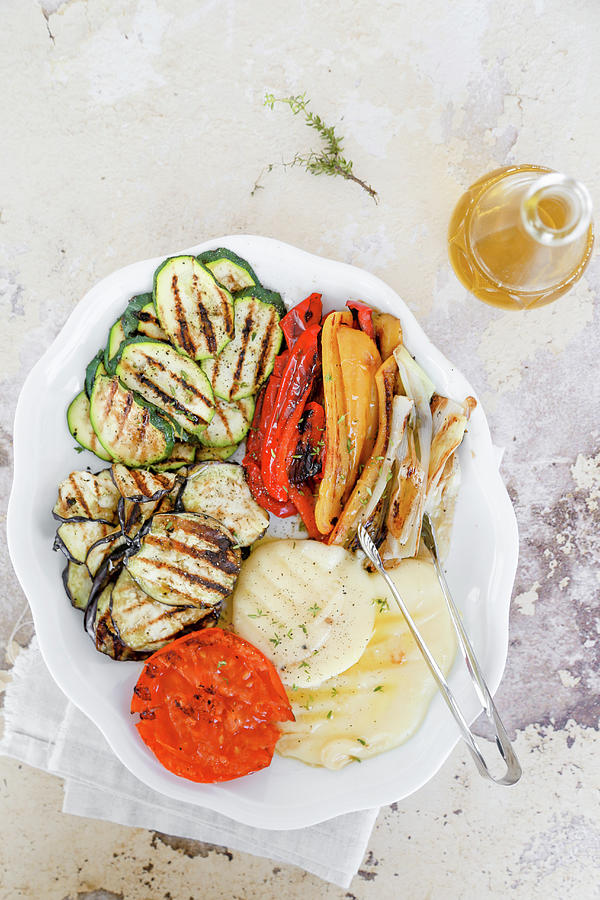 Dish With Grilled Vegetables, Courgettes, Aubergines, Peppers, Tomatoes, Spring Onions, And Scamorza Photograph by Claudia Gargioni