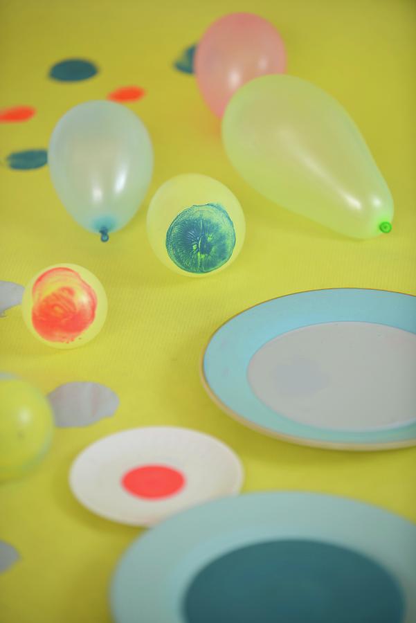 Dishes Of Paint And Balloons With Circles Of Paint Photograph by Studio27neun