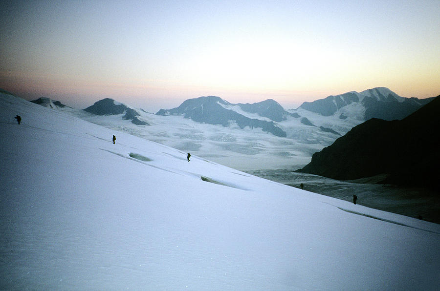 Distant Climbers Cross A Glacier In The Photograph by Mark Fisher