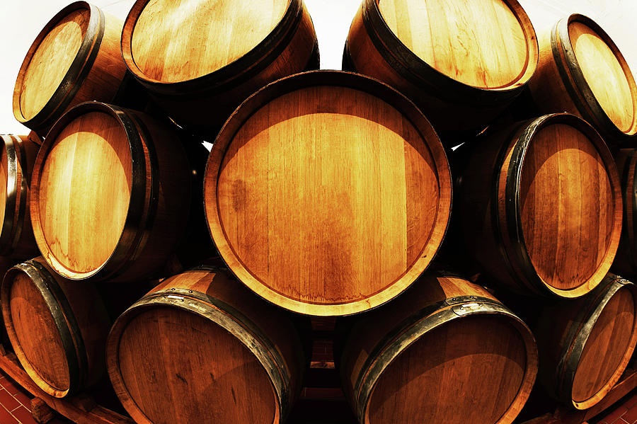 Distorted View Of Stacked Wine Barrels Photograph by Rapideye