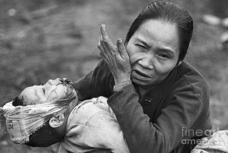 Distraught Vietnamese Woman Holding Photograph by Bettmann