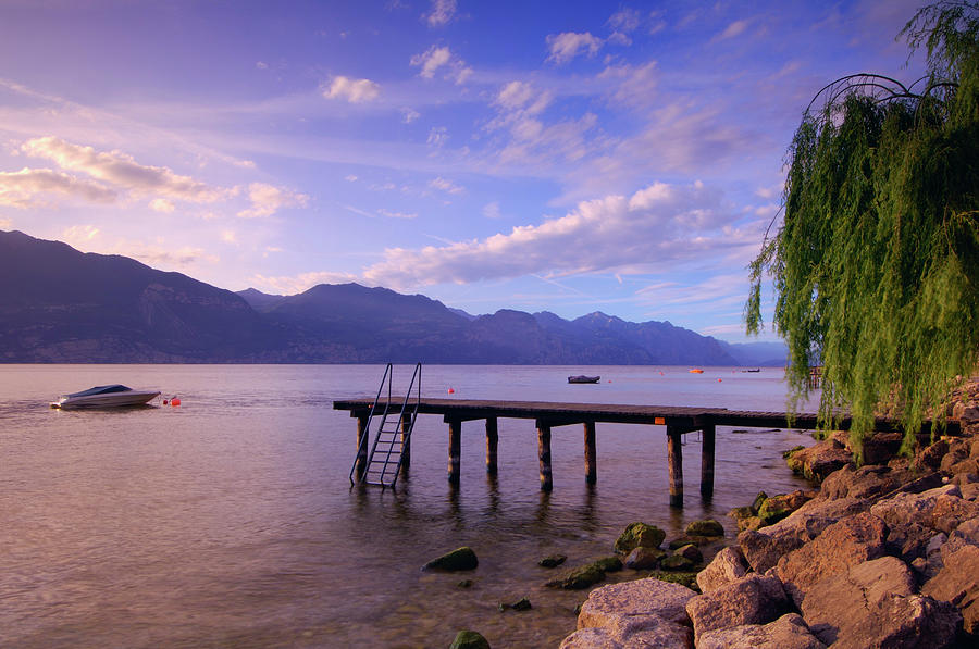 Dock And Boat On Lake, Lago Di Garda Photograph by Radius Images Dock And Boat On Lake, Lago Di Garda Photograph by Radius Images