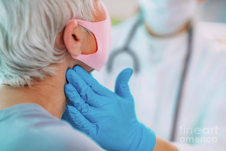 Doctor Examining A Senior Womans Neck Photograph by Microgen Images/science Photo Library