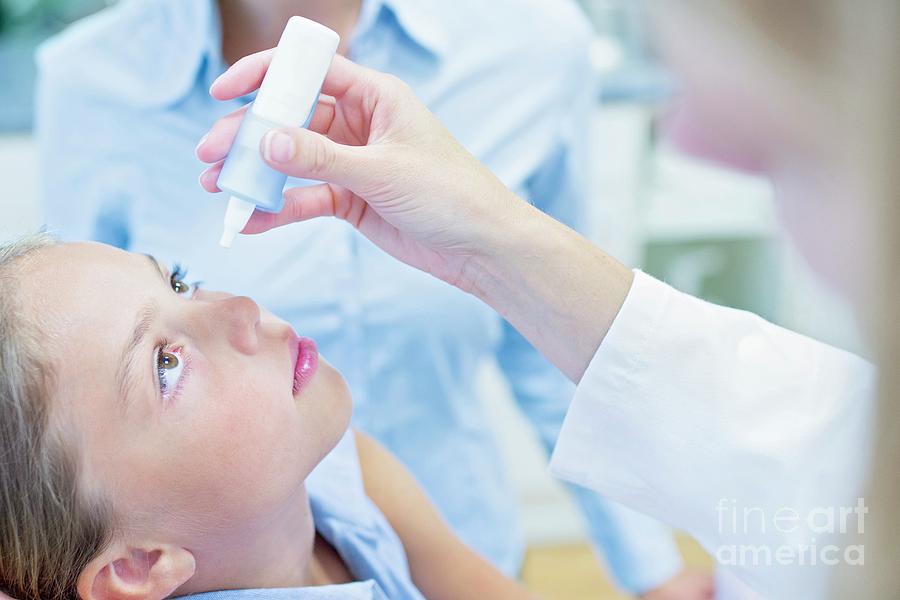 Doctor Putting Eye Drops Into Girl's Eye Photograph by Science Photo