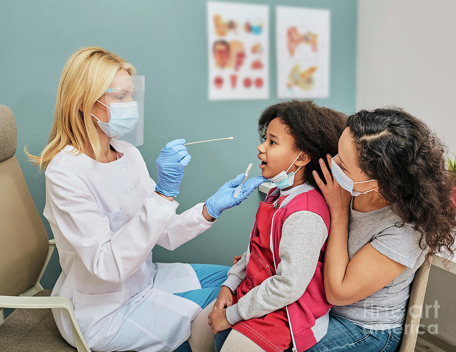 Doctor Taking Oral Swab by Peakstock / Science Photo Library