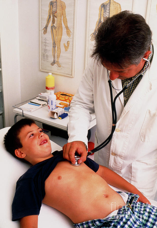 Doctor With Stethoscope Examines Young Boy Photograph by Mauro Fermariello/science Photo Library