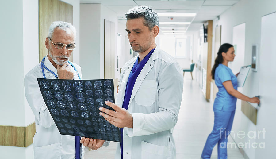 Doctors Discussing Mri Scan Photograph by Peakstock / Science Photo Library