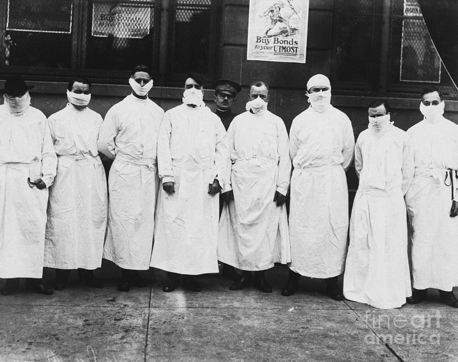 Doctors Wear Surgical Gowns And Masks By Bettmann