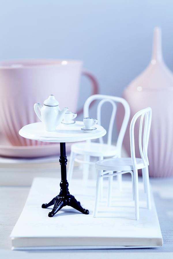 Dolls House Furniture With Real Crockery In The Background Photograph by Taube, Franziska